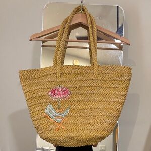Woven Straw Tote Bag with Pink Floral Embroidery and blue polka dot lining.